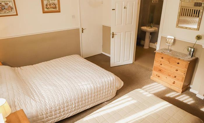 Family bedroom with full bathroom suitable for dis